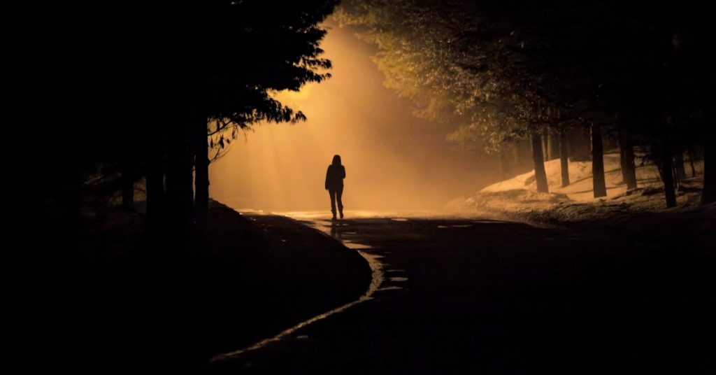 Person walking in a forest path